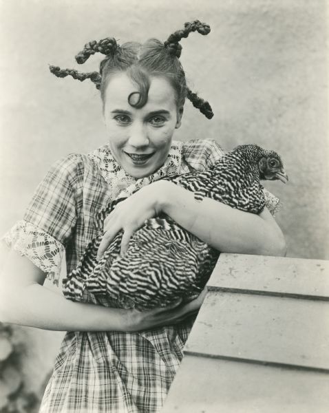 Publicity still of Louise Fazenda in her country girl costume holding a chicken, possibly for the 1920 Mack Sennett film <i>Down on the Farm.</i>