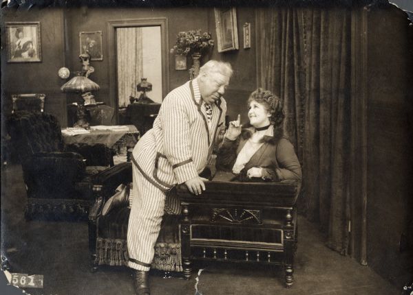Scene still from the Vitagraph production <i>Father's Flirtation</i> with John Bunny and Louise Beaudet. Bunny wears a boldly striped suit.