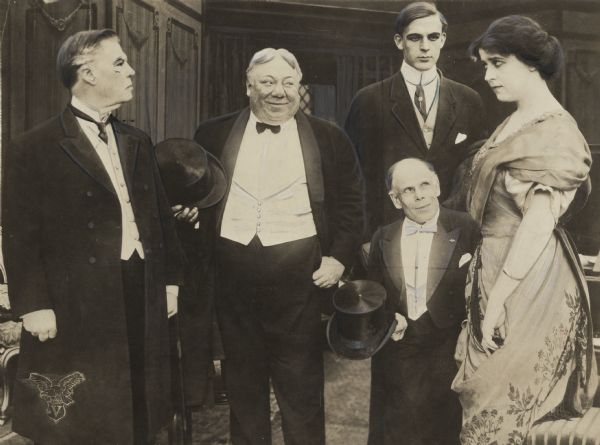 Heavily retouched scene still from the 1912 Vitagraph production <i>Chumps</i>. Left to right: William Shea, John Bunny, Wallace Reid, Marshall P. Wilder, and Leah Baird.
