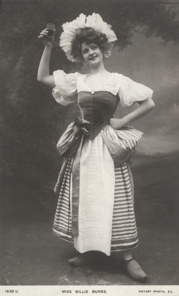 Billie Burke raises a glass posed as the servant girl in the operetta <i>The Dutchess of Dantzic</i> which premiered in October 1903 at the Lyric Theatre in London, England.