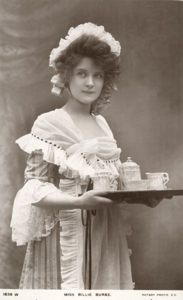 Billie Burke carries a tea tray as the servant girl in the operetta <i>The Dutchess of Dantzic</i> which premiered in October 1903 at the Lyric Theatre in London, England.