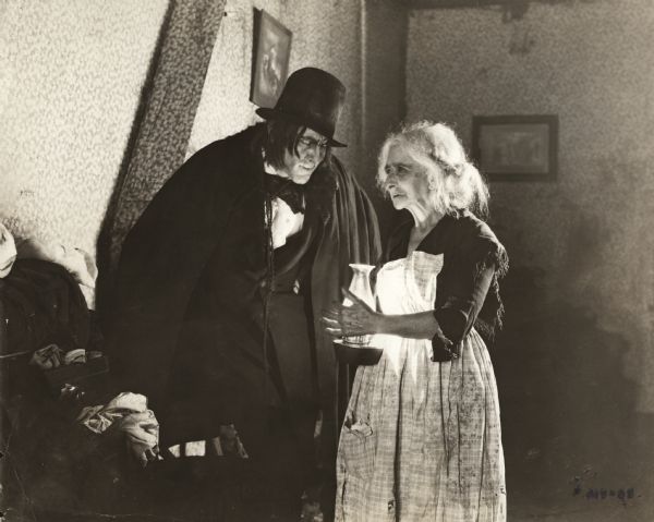 John Barrymore, as Mr. Edward Hyde, rents a shabby room from an old woman in a production still from <i>Dr. Jekyll and Mr. Hyde</i> (Famous Players-Lasky 1920).