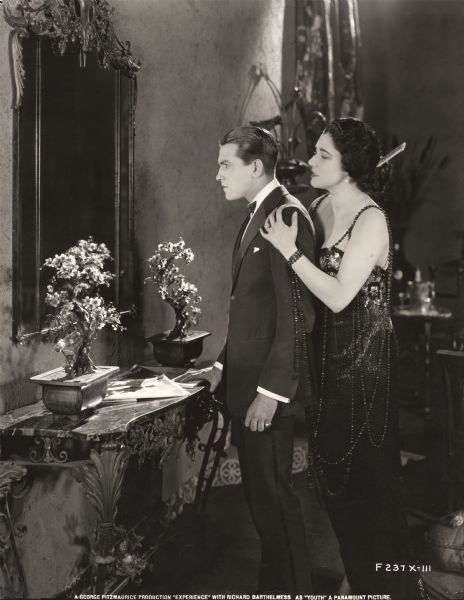Youth (played by Richard Barthelmess) is given the full treatment by Temptation (Nita Naldi) in the 1921 George Fitzmaurice production <i>Experience</i>.