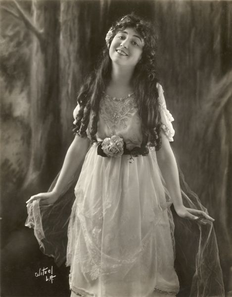 Three-quarter length portrait of Vola Vale, silent film actress who was a leading ingenue for the Balboa Amusement Producing Company.