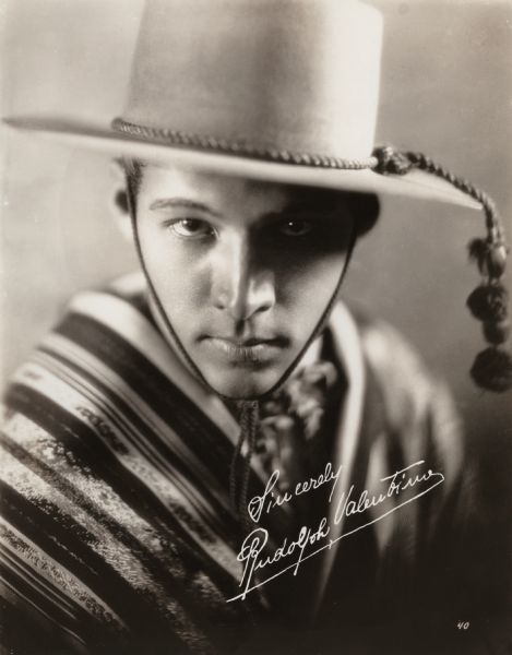 Head and shoulders portrait of Rudolph Valentino as Julio Desnoyers in the 1921 Metro Pictures production <i>The Four Horsemen of the Apocalypse.</i> He is dressed as a gaucho.