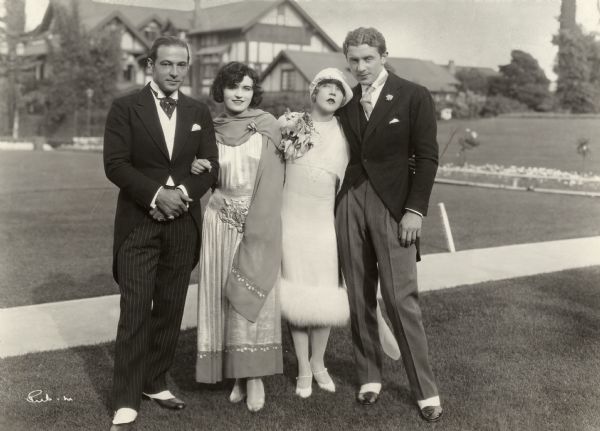 Full-length portrait of two couples, Rudolph Valentino with Pola Negri, and Mae Murray with Prince David Mdivani, apparently taken the day of Murray and Mdivani's wedding. Valentino was Mdivani's best man at the ceremony.