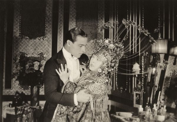 Rudolph Valentino, playing Juliantino Visconti, and Dorothy Phillips, as Aurora Meredith, in a tense embrace from the 1920 Universal production <i>Once to Every Woman,</i> a lost film. Dorothy Phillips wears an extravagant oriental costume.