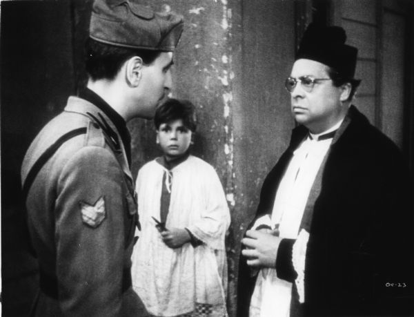 Scene still of Aldo Fabrizi, as the priest Don Pietro Pellegrini, confronted by a police sergeant, Eduardo Passarelli, in Roberto Rossellini's <i>Roma, città aperta (Rome, Open City)</i>.