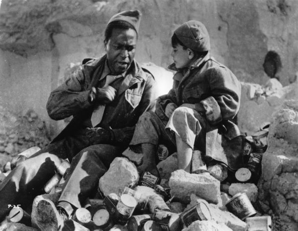 The black American soldier Joe (played by Dots Johnson) and the Italian street urchin Pasquale (Alfonsino Bovino) in a publicity still from Roberto Rossellini's <i>Paisà (Paisan,</i> 1946).