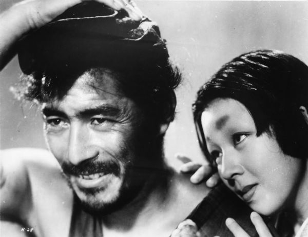 Publicity still of Tohiro Mifume as Tajomaru the bandit and Machiko Kyo as his wife Masago in Akira Kurosawa's <i>Rashomon</i> (1950).
