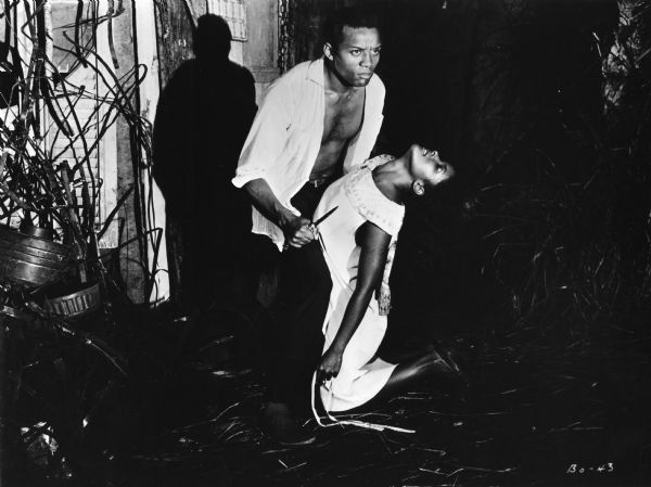 Scene still of Breno Mello, as Orfeo holding a knife, and Marpessa Dawn, as Eurydice, in Marcel Camus's <i>Orfeu Negro (Black Orpheus,</i> 1959).