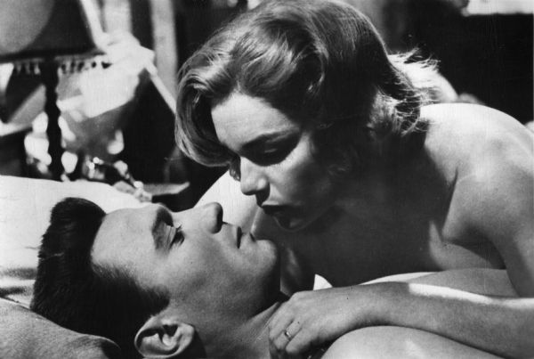 Scene still of Laurence Harvey, playing Joe Lampton, in bed with Simone Signoret, as Alice Aisgill, in Jack Clayton's <i>Room at the Top</i> (1958).