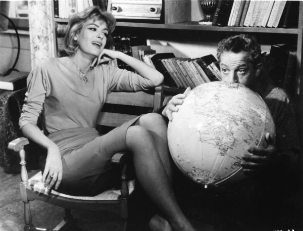 Homer Thrace (played by Jules Dassin) is inflating a globe for the prostitute Ilya (Melina Mercouri) whom he is trying to educate in Dassin's <i>Pote tin Kyriaki (Never on Sunday,</i> 1960).

