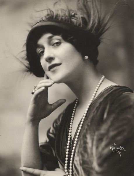 Publicity portrait of the Italian operatic soprano Lina Cavalieri in pearl necklace and feather covered hat made when she appeared in Famous Players-Lasky silent film productions.