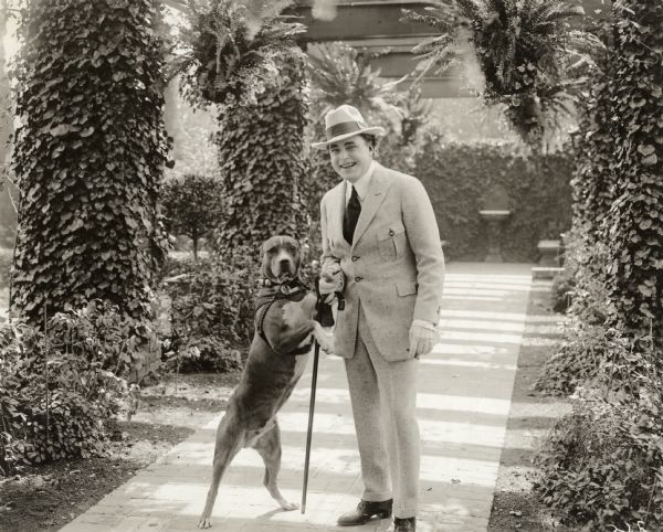 William Farnum and his dog at his home in Hollywood.