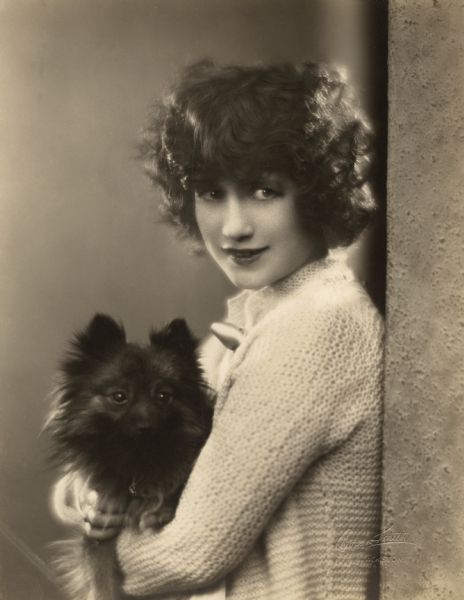 Francine Larrimore, Broadway star and briefly a silent film actress, with her dog, perhaps a miniature spitz.