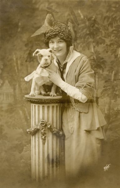 Vitagraph silent film star Eleanor Woodruff and a bulldog puppy in a White Studio portrait retouched for newspaper use.