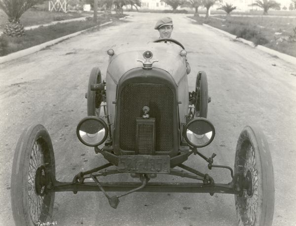 Goldwyn silent film star Cullen Landis behind the wheel of a racing car with 1921 California license plates.  Original caption: "Here's Cullen Landis in his high-powered racing car."