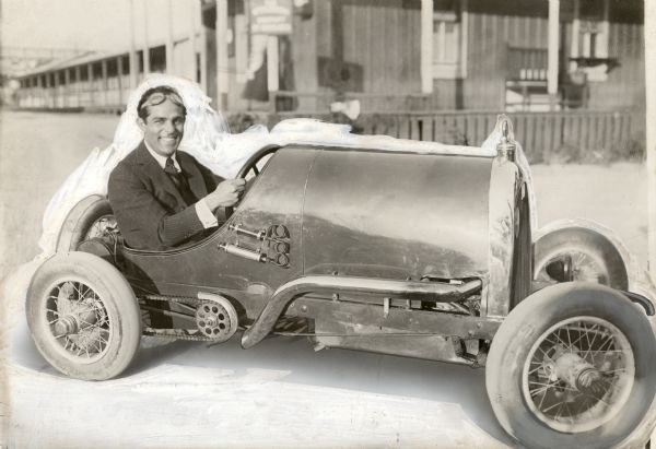 Vitagraph silent film star Antonio Moreno sits grinning beind the wheel of a very small racing car in a photograph heavily retouched for print reproduction. The miniature automobile is an Al Smith Special, no doubt the same car mentioned in the advertisement below:

ACTORS' FUND FESTIVAL
"Five mile auto race between Tony Moreno in Art Smith baby racer and Tod Sloan driving the Stagg-Packard Special."
<i>Los Angeles Times,</i> 3 June 1921, p. II 10.