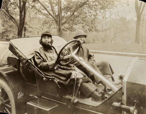 Silent film star Pearl White behind the wheel of a 1915 Stutz Bearcat roadster with journalist George Vaux Bacon sitting beside her. The photograph was made to accompany an article Bacon was writing for the January 1916 issue of <i>Photoplay Magazine</i>.