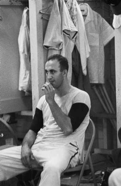 Milwaukee Braves first baseman Frank Torre enjoys a cigar in the Braves lockerroom.  A left-handed defensive specialist, Torre filled in for the injured Joe Adcock at first base during 1957, batting .272 in 129 games.  He batted .300 and hit two home runs in the 1957 World Series.