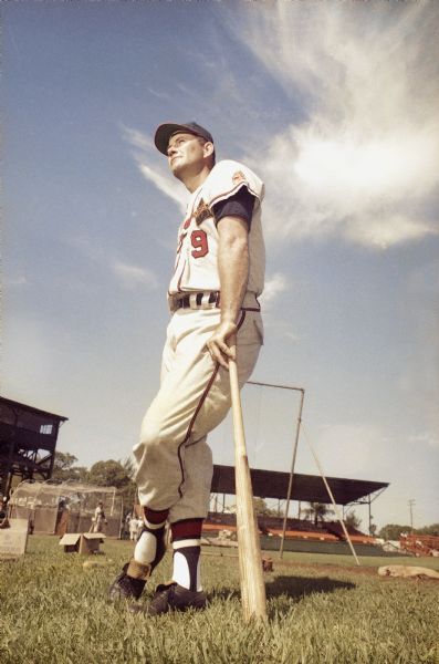 Portrait of Milwaukee Braves first baseman Joe Adcock leaning on a bat.  Image was taken during spring training, 1961.