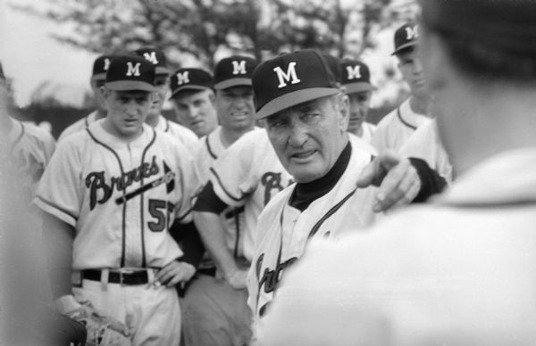 Milwaukee Braves manager Fred Haney instructing his players. Andy Pafko is visible immediately to the left of Haney's cap.