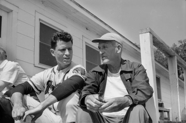 Milwaukee Braves outfielder Andy Pafko (left), at spring training with an unidentified individual.  Pafko, who was born in Boyceville, Wisconsin, was platooned with Bob Hazle in right field in 1957, starting against left-handers. In the 1957 Series, Pafko singled and scored a run in the Braves' 4-2 victory in Game 2. Pafko was named to National League All-Star teams in 1945 and 1947-1950 while playing for the Chicago Cubs and played in the 1945 and 1952 World Series before becoming a Brave in 1953.