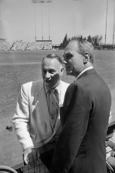 Milwaukee Braves owner Lou Perini and Wisconsin Governor Walter J. Kohler, Jr. converse at the baseball All-Star game held at Milwaukee County Stadium, July 12, 1955.