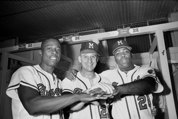 Milwaukee Braves players Henry Aaron (left), Warren Spahn (center) and Tommie Aaron (right) in the Braves' locker room. Tommie Aaron, younger brother of Henry Aaron, played for the Milwaukee Braves in 1962-63 and 1965.