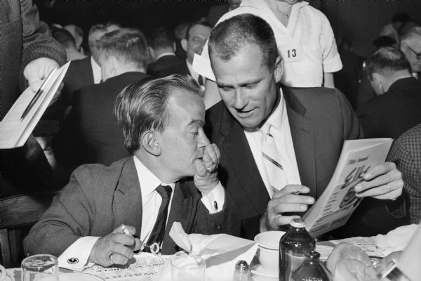 Donald Davidson (left), Director of Public Relations for the Milwaukee Braves, talks with pitcher Lew Burdette at an Elks club dinner.