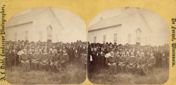 "View of the ministers present" from the "Dedication of Blue Mounds Church" section of Dahl's 1877 "Catalogue of Stereoscopic Views." The congregation of the East Blue Mounds Lutheran Church and visiting ministers are gathered for the church dedication August 30, 1876. The church was formerly Norsk Evangelisk Kirke, built in 1868.