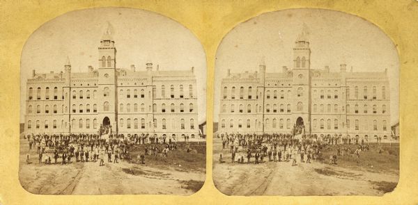 Luther College in Decorah, Iowa, with a crowd of students in front. Identified in Dahl's 1877 "Catalogue of Stereoscopic Views."