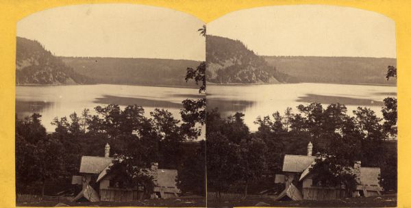 An elevated view of Devil's Lake with a cabin in the foreground.