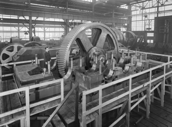 TCD drives that were purchased by U.S. Steel (Allegheny Project) and used by Gary Steel Works. Falk caption reads, "Various manufacturing and assembly photos of TCD secondary drives on Allegheny project." The man in the photograph is R. Gosh.