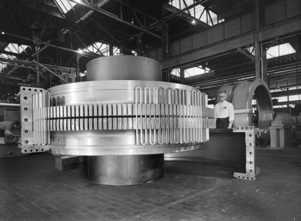 Couplings that were purchased by U.S. Steel (Allegheny Project) and used by Gary Steel Works. The man in the photograph is D. Ferch. There is also a man working on the left side of the coupling.
