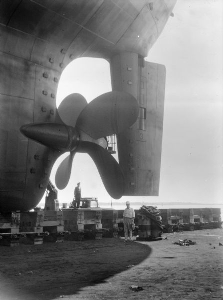 Propeller of the S.S. <i>Santa Cruz</i>. Falk caption reads, "Photos taken for reference in study of propeller reversing characteristics for SUN Marine red. gear. Man that is identifiable in photograph is Gerald Swensson of Sun Shipbuilding and Dry Dock Company."