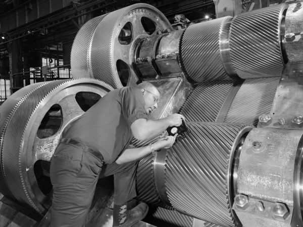 Double reduction reverse gear that was later purchased by Sun Shipbuilding and Dry Dock Company. Falk caption reads: "Photos taken for possible use as glamor illustrations of Falk gears." Male employee in photograph is L. Babcock.
