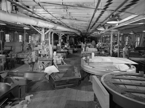 Original Falk caption reads, "General view of the pattern shop taken as part of Allis Chalmers-Duval." Photo series for Bill Wyse. The core box in the foreground is representative of some coregraph box components used to manufacture large split ring gears. Men in photo are E. Kothrade, W. Mimberger, J. Satorus, R. Schienbein, K. Guetz, A. Kaja, A. Dziomba, R. Reimer, and C. Seui."