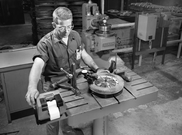 Original Falk caption reads, "Views of bevel gear inspection equipment for future use-a product quality control publication." Man in photograph is Rob Schaurer."