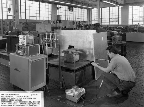 A male employee, Karl Johns, attends to a sound test.