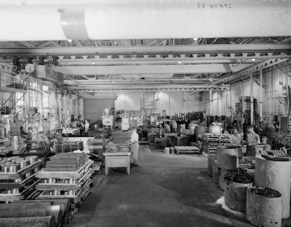A view looking west of several workers in the Heat Treating Department of the Falk Corporation.