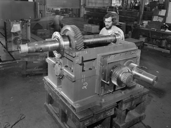 This unit was purchased and used by the the Aluminum Company of America. Falk caption reads, "8 units on the order. 3 units are shiftable, the balance of fine are not... see Engineering File for exact specifications." Male employee in photograph is Robert Kieser.
