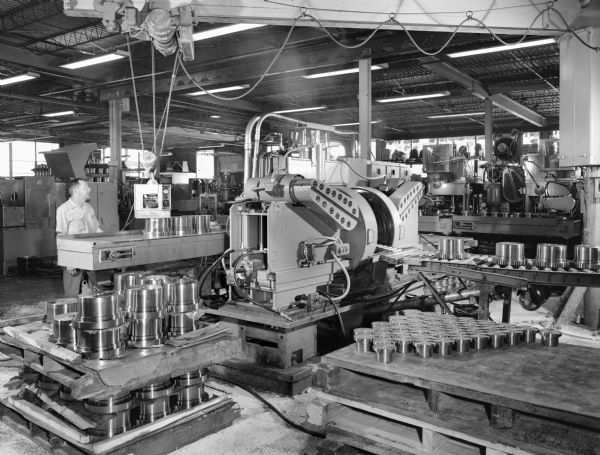 Original Falk caption reads, "These pictures of Machine number 7409 taken for Jack Blank to use as illustration(s) of Falk slotter to gain approval to use a similar machine in Brazil." Male employee in photograph is Rolondo Medrono.