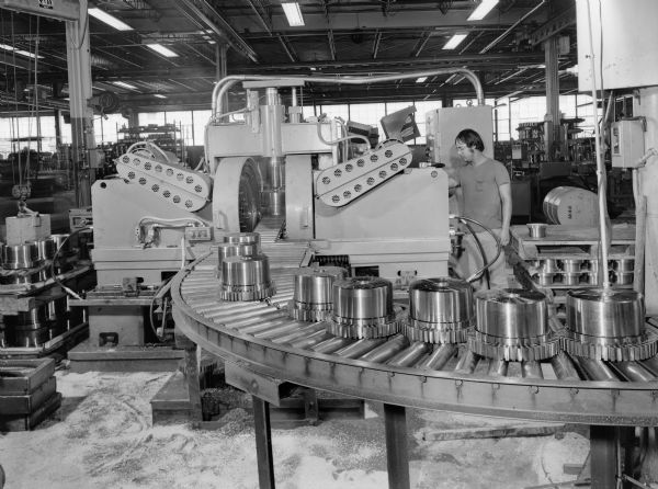 Original Falk caption reads, "These pictures of machine number 7409 for Jack Blank to use as illustration of a Falk slotter to gain approval to use a similar machine in Brazil." Male employee in photograph is G. Anderson.