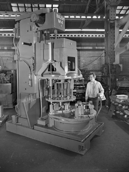 Bill Wagner, a Falk employee, attends to a large coupling sleeve. This unit was later used by the Auburn Plant-Baush Drill Press. Original Falk caption reads, "This machine and tooling is the property of the Auburn Plant."
