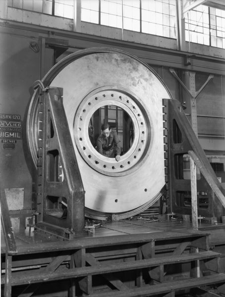 Gerald Gosetti, a Falk employee, inspects a large vertical roller mill. This particular mill was purchased by combustion engineering and used by Marquette Cement, both of Cap Girardeau, Missouri.