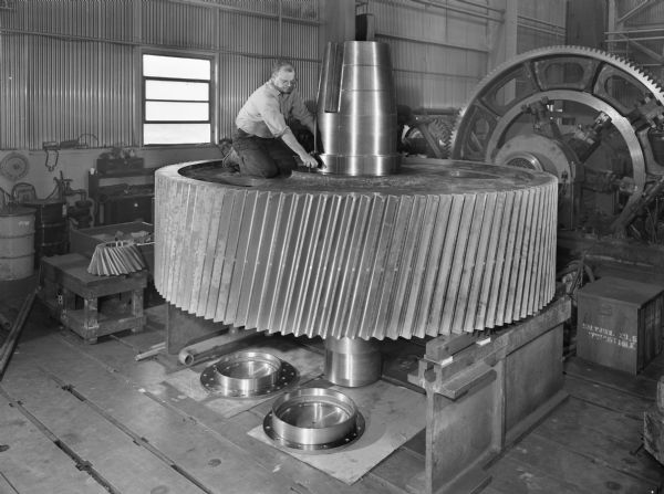 Melvin Zdroik, a Falk employee, attends to a large vertical roller mill that is a later component of a L.S. Shaft and Gear. This unit was purchased by Combustion Engineering and used by Marquette Cement, both of Cape Girardeau, Missouri.