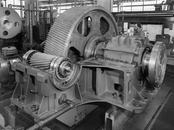 Non-reversing marine gear that is a component of a marine propulsion drive. This unit was purchased by the Electro-Motive division of the General Motors Company and used by Bay Shipbuilding. Original Falk caption reads, "252ZMA twin pinion on-reversing marine propulsion drive for Bay Shipbuilding hull number 723... See Engineering File for exact specifications." Male employee in photograph is Robert A. Kieser.