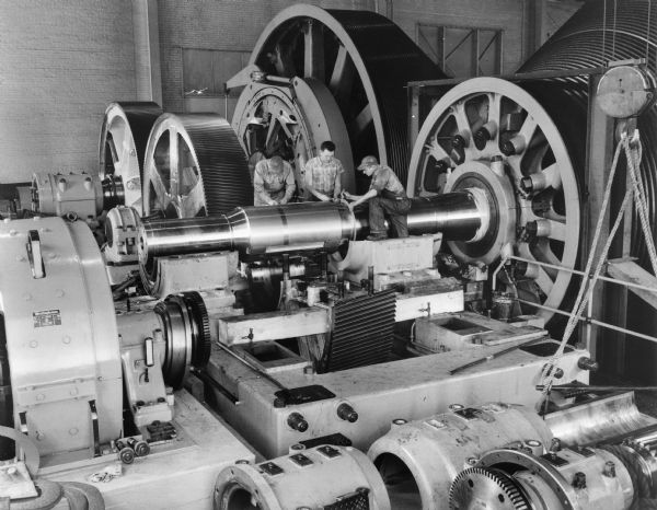 Single helical gear train that is a component of a gold mine hoist. This unit was purchased and used by Homestake Mining of Lead, South Dakota. Falk caption reads, "One of the largest hoists in the world at time of installation. Each motor is 1500 HP 350 RPM. Motors and pinions couple by size 240F Steelflex coupling. Pictures obtained as a possible story about Falk in a future Handy Facts on gold and minerals. Photos obtained by Rick Burgermeister, Denver office. Original returned to Homestake.
